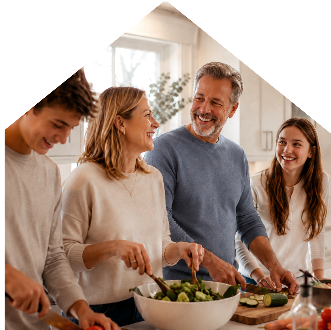 Family cooking together in their kitchen at home