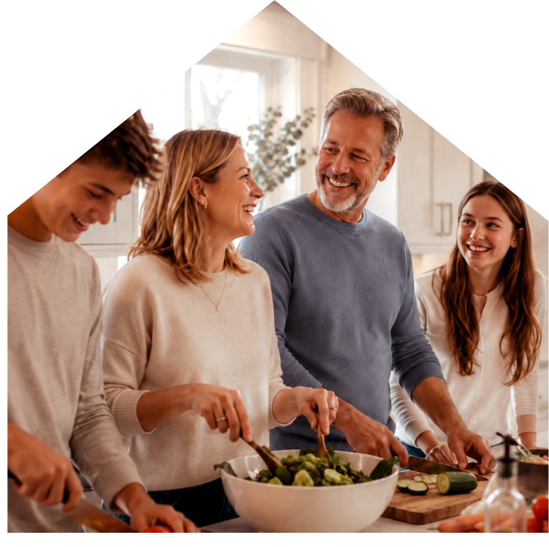 Family cooking together in their kitchen at home